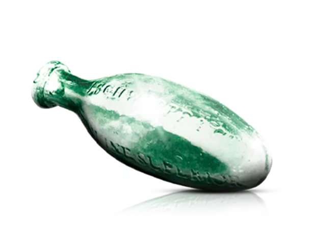 Eine grüne Flasche in Eiform, liegend gelagert.