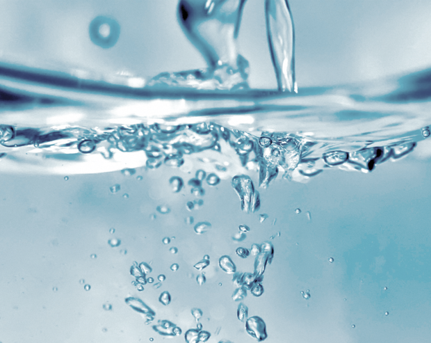 Nahaufnahme von Wasser mit Blasen, die Wasserqualität symbolisieren.